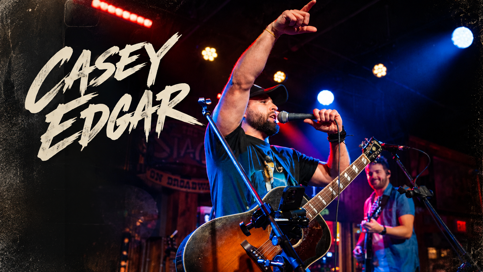 Casey Edgar singing and playing guitar onstage, with Casey Edgar lettering